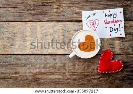 card for Valentines day, red toy heart and a cup of coffee on a dark wood background. toning. selective Focus Royalty-Free Stock Photo #355897217