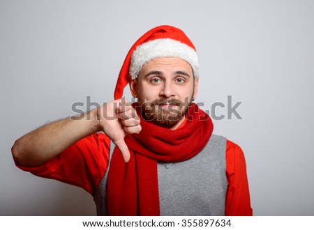 Bad news for you. Business man showing his finger down in the winter. Corporate party, Christmas hat isolated portrait of a man on a gray background, studio photo.