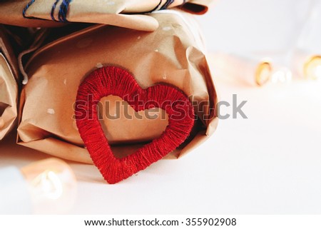 Stylish craft presents with red heart, happy valentine's day, holiday greeting card concept