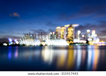 Blurred bokeh abstract motion of Singapore Skylines, Downtown and Financial District buildings reflection along the Singapore River at Blue Hour. Colorful bokeh lights  background of Modern City 