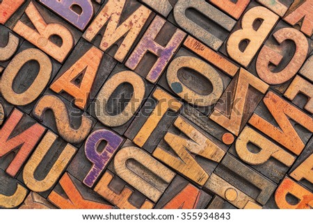 wood type alphabet abstract with a grunge texture - letterpress printing blocks stained by color inks Royalty-Free Stock Photo #355934843