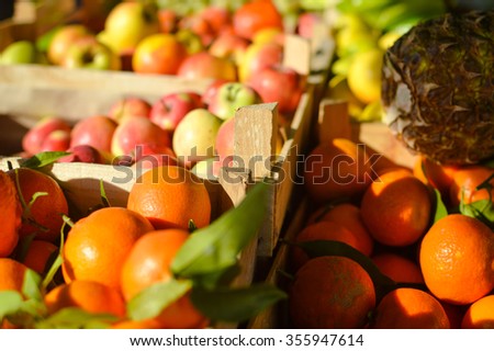Picture of fresh fruits and vegetables at market in boxes on colorful background
