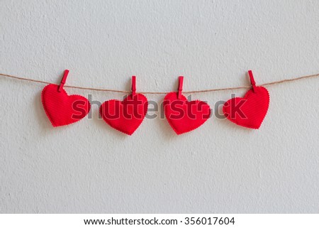 Red heart decoration hanging over wall grunge background, Valentine day concept.