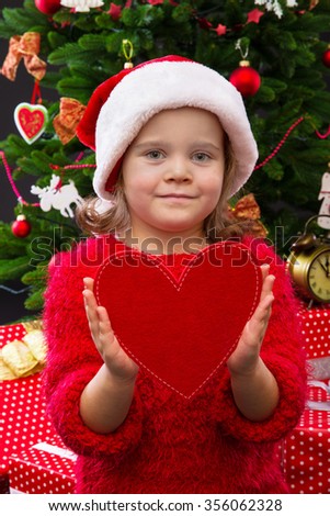 Portrait of a little girl holding red heart

