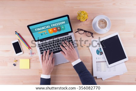 Businessman is working on desk - FINANCIAL FREEDOM Royalty-Free Stock Photo #356082770