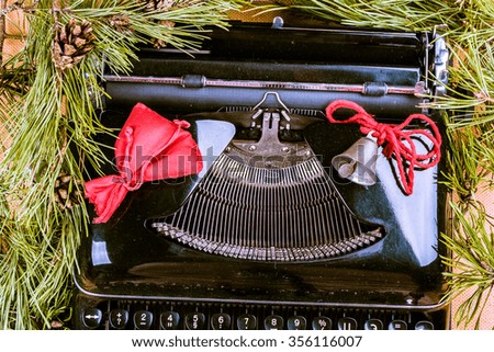 Vintage typewriter with Christmas tree fur. Photography for blog and creative banners, or hero image. Symbol of blogging, writing, internet activity and creativity.