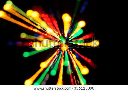 Abstract multicolored light beams in motion, light painting on a black background. Rainbow