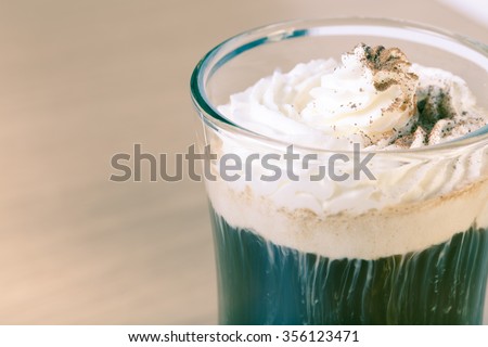 Cup of coffee with whipped creams. Selective focus. Toned.