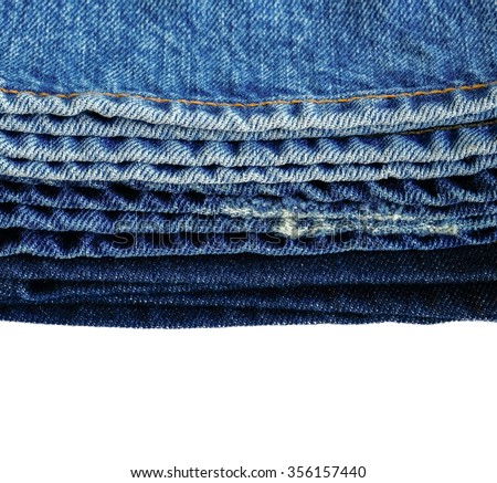 Stacked of blue jeans or denim, abstract background isolated
