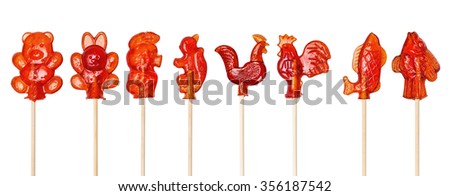 Set of red sugar lollipops made in the shape of cockerels, fishes, goldfishes, squirrel, Piglet, bear, hare on a wooden stick, isolated on the white