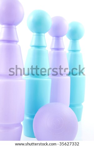 Blue and purple colored bowling pins with ball, isolated on white background