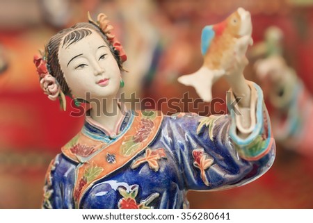 Sculpture of a traditional dressed woman, Panjiayuan Market, Beijing, China