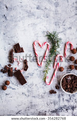 Crushed candy cane and chocolate sliced on a stone background. country style. Symbol heart. 