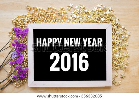 Happy New Year background decoration with 2016 number on blackboard over wooden table, Happy New Year concept