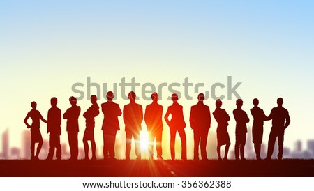Silhouette of business people of different professions on sunset background