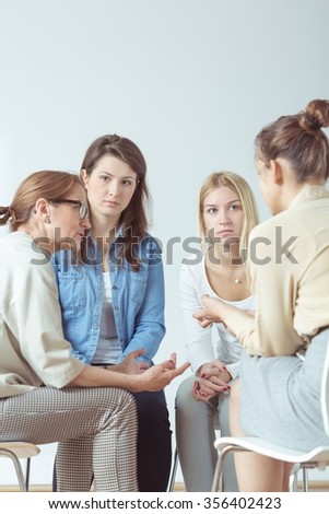 Young woman confiding problem to her support group