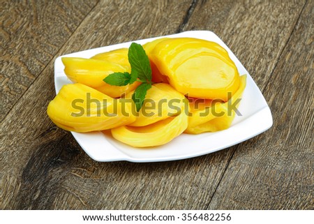 Jackfruit with mint leaves in the bowl on wood background