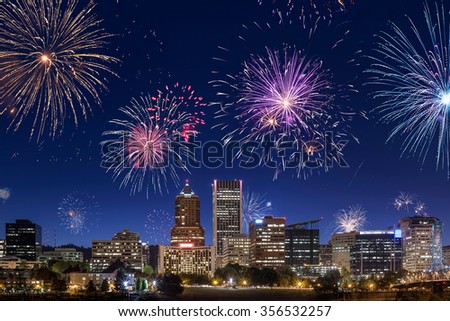 Direct view on Portland's downtown buildings and skyscrapers during night with fireworks on the sky