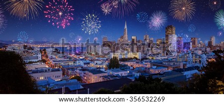 Downtown San Francisco cityscape with Bay Bridge and flashing fireworks Celebrating New Years Eve