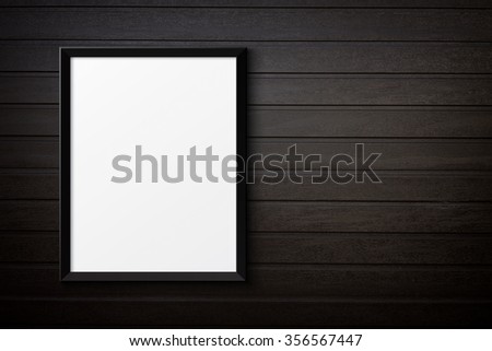 Blank black picture frame on the painted wood texture