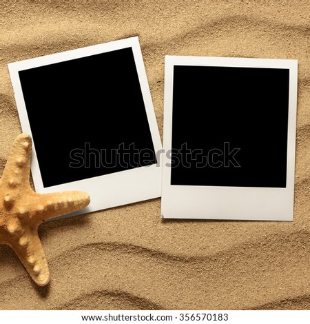 Photo frame on sand background. Close up