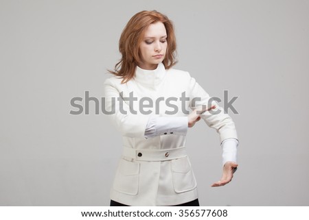 Woman holding something in hands on gray background