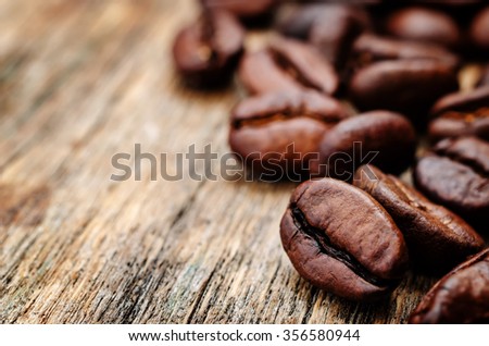 coffee beans on a dark wood backgound. toning. selective Focus