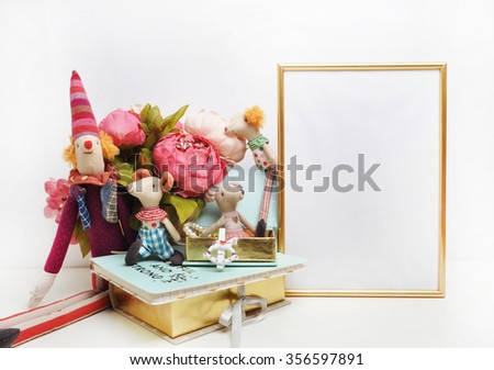 Gold frame mock-up, and white wall with toys.mouse, circus.
Place work