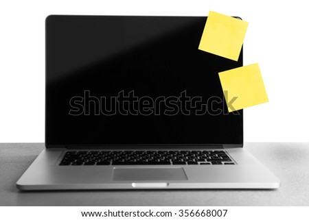 Empty yellow adhesive papers on laptop, on light background