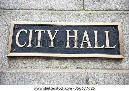 A blue colored plaque mentioning City Hall attached to the wall of the Chicago City Hall and County Building in Chicago, Illinois. It is one of the oldest buildings in the city.