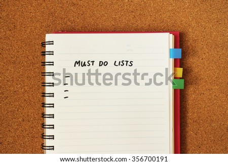 Must do list message in handwritten style with blank space to fill in the text. Blank page of notebook organizer with bookmark on cork board background.
