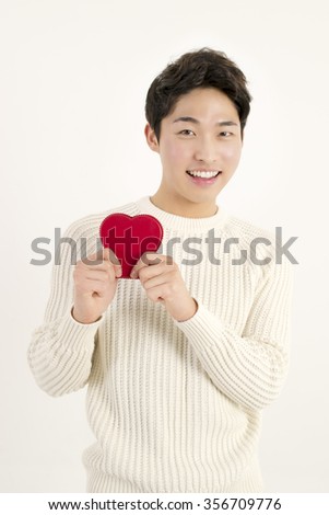 Smiling man with red heart