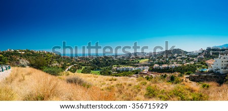 Panoramic View Of Mijas city In Malaga, Andalusia, Spain. Summer Cityscape. The Village With Whitewashed Houses. Summer Sunny Day With Clear Blue Sky