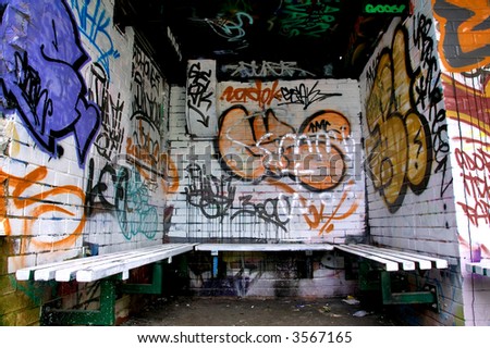 Graffiti on the walls surrounding a seating area.