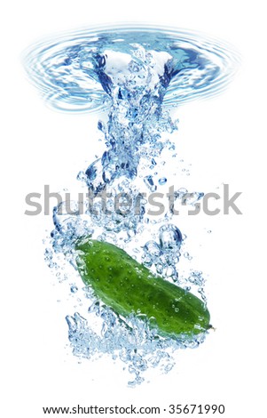 A background of bubbles forming in water after green cucumber are dropped into it.