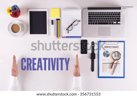Businessman working on desk - hands showing CREATIVITY concept