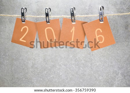 new year 2016 word hanging on the Notes paper cards in clothes pegs on rope