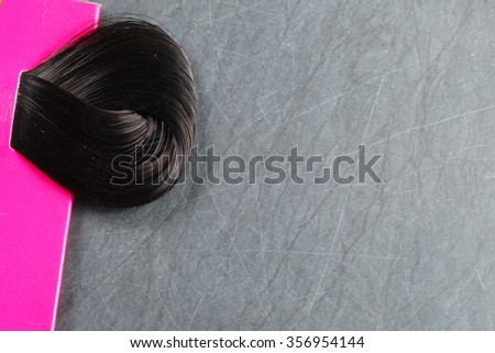 The hair coloring on slate board background  represent the hair coloring make up and beauty concept related idea. 