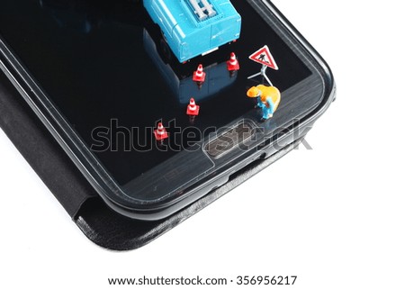 The mobile phone and maintenance figure miniature model put on screen panel in the scene focus at button represent mobile phone maintenance and toy concept related idea. 