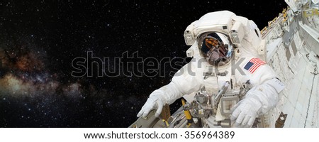 Astronaut on space mission with the outer space on the background. Elements of this image furnished by NASA.