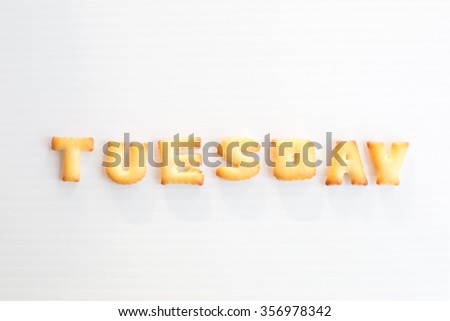 word tuesday made of biscuits on white background