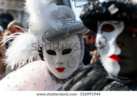 Mask carnival in the unique city of Venice in Italy. Venetian masks. Venice Carnival procession/Organized parade is walking along a channel in Venice during the Carnival. 