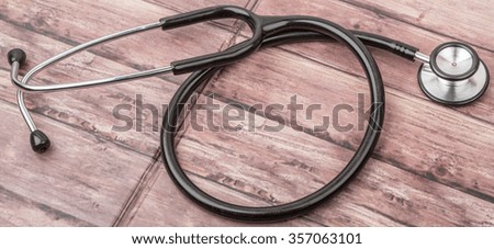 Medical stethoscope over wooden background