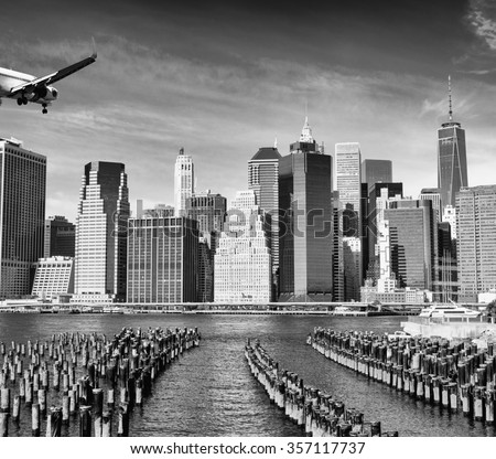 Black and white view of airplane over New York City. Tourism concept.