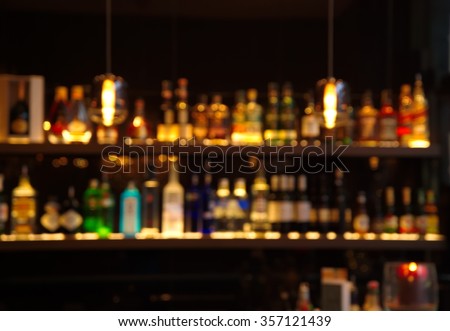 blur alcohol drink bottle at club pub or bar in dark party night background Royalty-Free Stock Photo #357121439