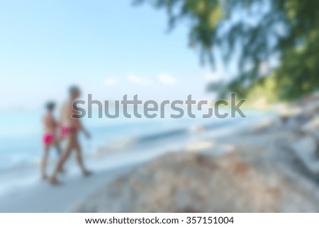 foreign tourists walking at the beach: blurred image