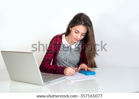 young girl studying with pocket calculator
