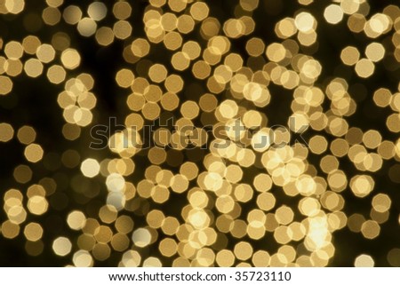 Abstract defocused background of golden sparkly lights