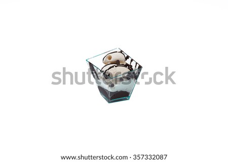 In the picture a cupcake with chocolate and cream in a plastic cup,isolated on white background.