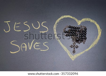 In the picture a rosary iron at the center of a heart drawn on the left side the word "Jesus saves" with a crayon